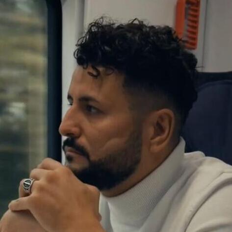 Ibrahim Arslan is travelling by train and looking out of the window.