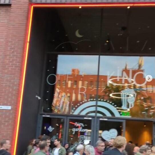 A crowd in front of a cinema